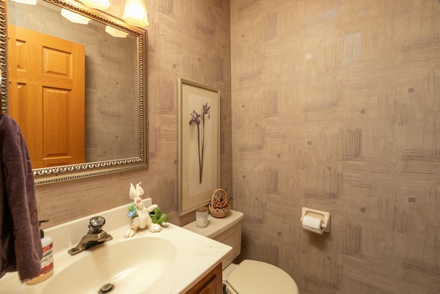 bathroom featuring toilet and vanity