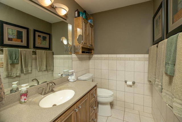 bathroom featuring tile walls, vanity, tile patterned floors, and toilet