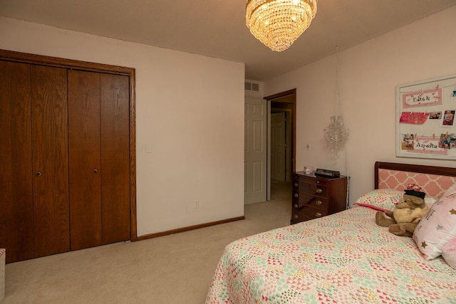 carpeted bedroom featuring a closet and a notable chandelier