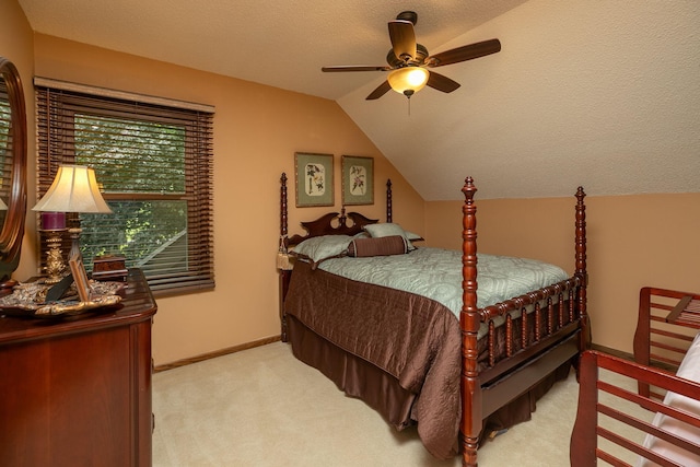 carpeted bedroom featuring lofted ceiling, a textured ceiling, and ceiling fan