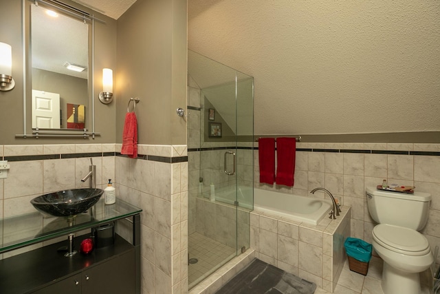 full bathroom with toilet, plus walk in shower, tile patterned floors, tile walls, and sink