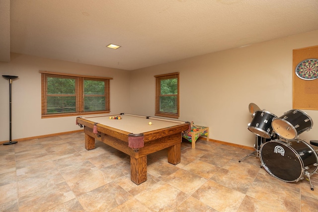 rec room with pool table and a textured ceiling