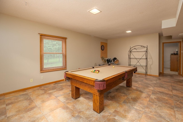 game room with pool table and a textured ceiling