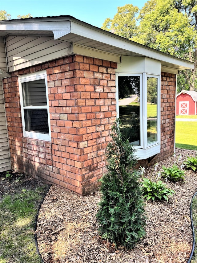 view of side of home featuring a shed