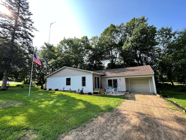 view of front of home with a front yard and a garage