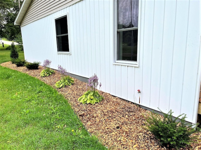 view of home's exterior featuring a yard and board and batten siding