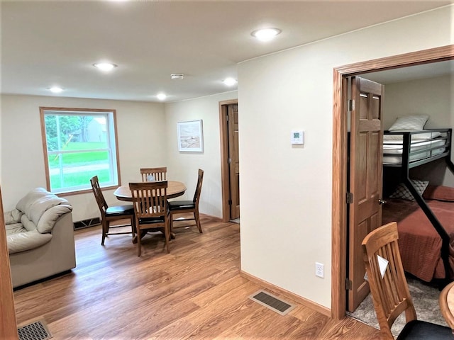 dining area with light wood-style floors, recessed lighting, and visible vents