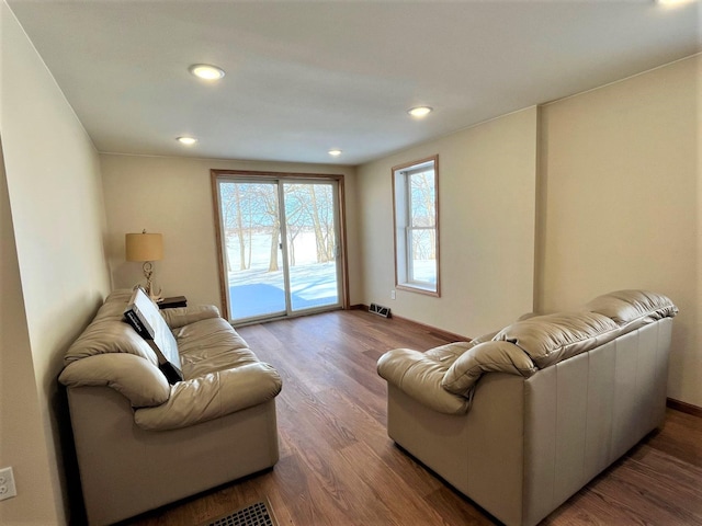 living room featuring recessed lighting, visible vents, baseboards, and wood finished floors