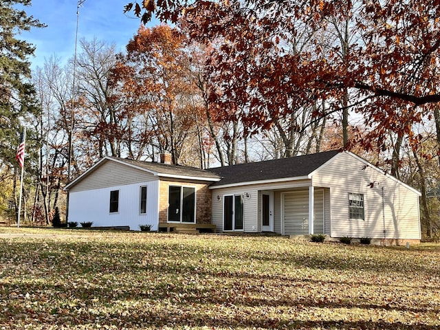 view of front facade with a front yard and a chimney