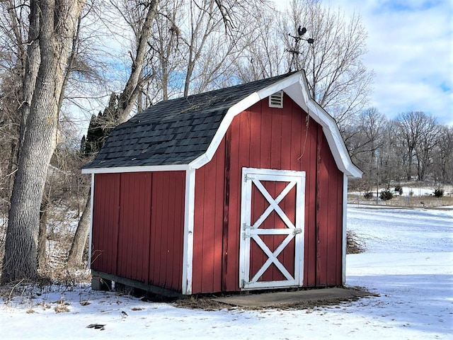 snow covered structure with an outdoor structure