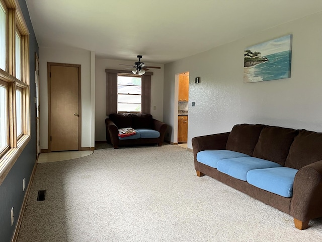 living room featuring carpet floors and ceiling fan