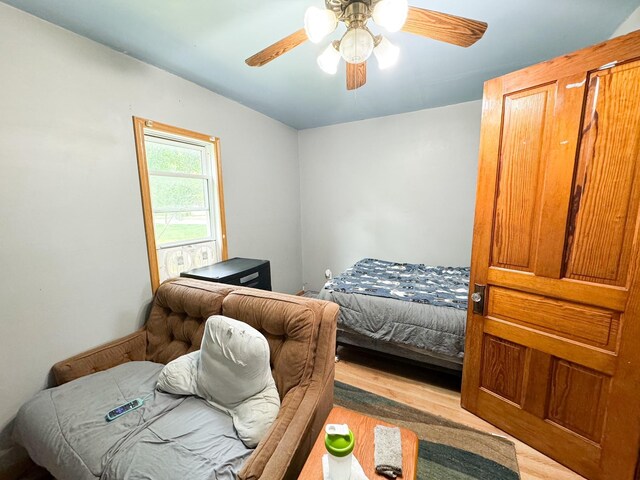 bedroom with light hardwood / wood-style flooring and ceiling fan