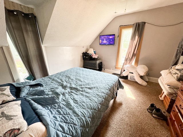 carpeted bedroom with a textured ceiling and lofted ceiling