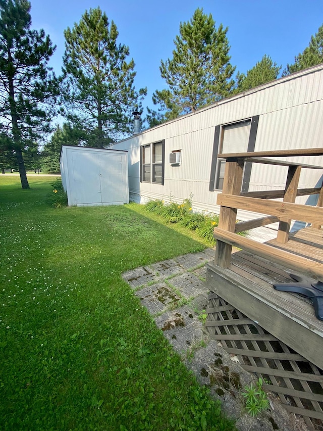 view of yard with a storage unit and a wooden deck