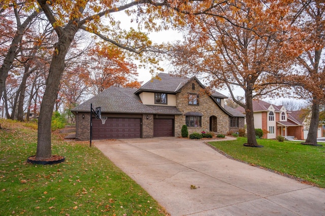 view of front of property with a garage and a front lawn