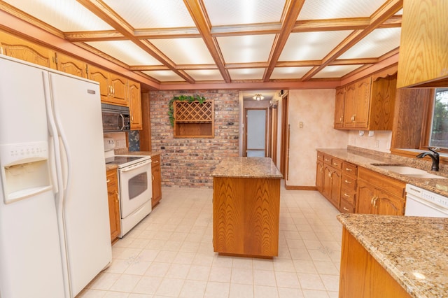 kitchen featuring coffered ceiling, white appliances, light stone countertops, a kitchen island, and sink