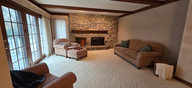 carpeted living room with a fireplace and beamed ceiling