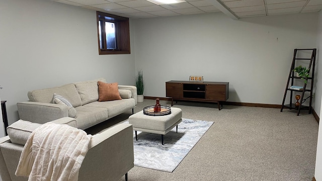 living room with a paneled ceiling and carpet flooring