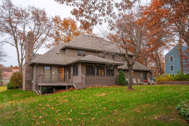 back of house with a wooden deck and a lawn