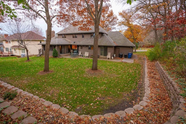 back of house featuring a yard and a patio