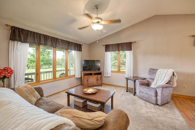 living room featuring a ceiling fan, lofted ceiling, and baseboards