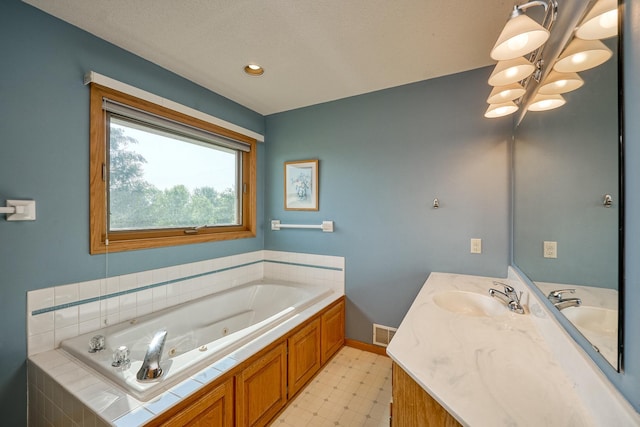 full bathroom with a chandelier, a jetted tub, tile patterned floors, vanity, and baseboards