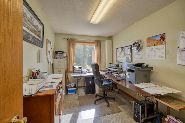 carpeted office space featuring a textured ceiling