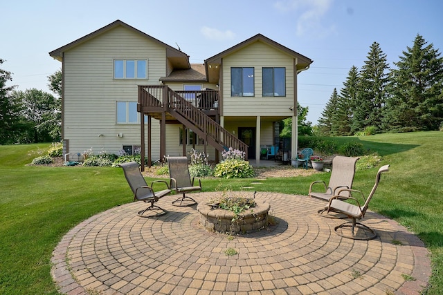back of property with a patio, stairs, a wooden deck, a fire pit, and a yard