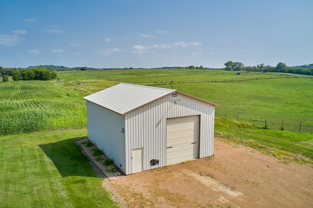 view of outdoor structure with a view of rural / pastoral area, dirt driveway, and an outdoor structure