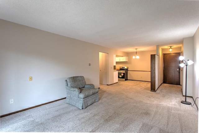 unfurnished room featuring light carpet and a textured ceiling