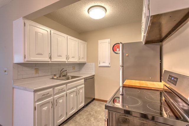 kitchen featuring white cabinets, stainless steel dishwasher, decorative backsplash, stove, and sink