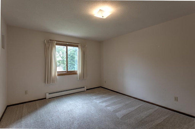 unfurnished room with carpet floors and a baseboard heating unit