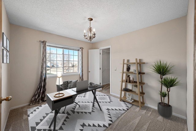 carpeted home office featuring a chandelier, a textured ceiling, and baseboards