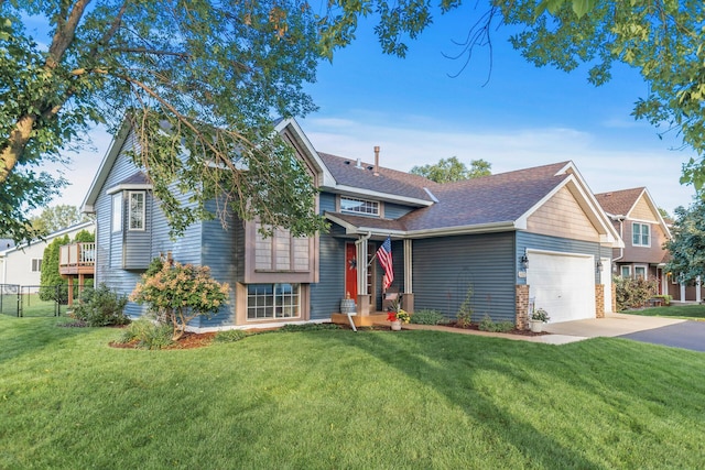 view of front facade with a garage, driveway, a front lawn, and fence