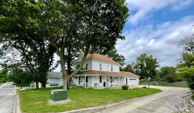 view of front of property with a garage and a front lawn