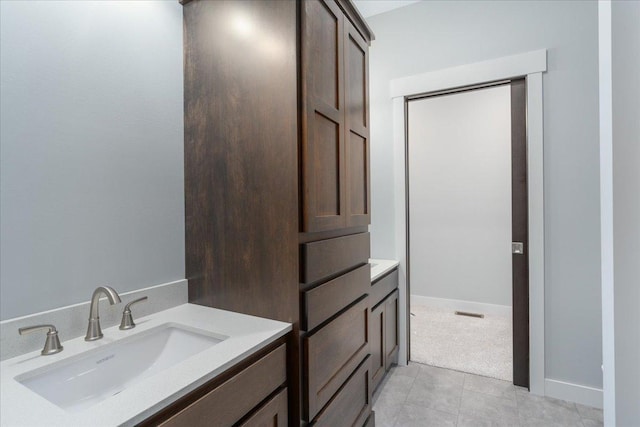 bathroom with tile patterned floors and vanity