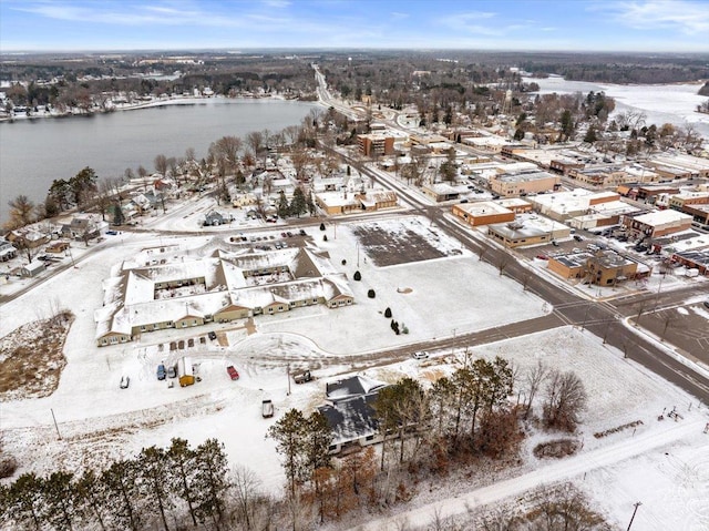 snowy aerial view with a water view