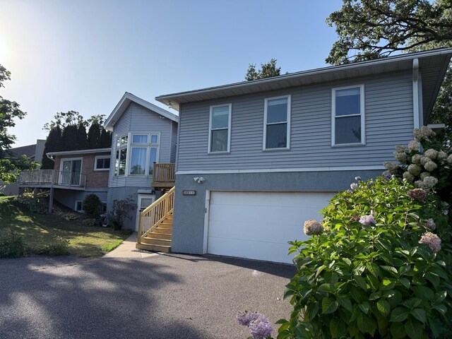 2211 Jennifer Ct N, Saint Paul, MN 55109 - view of front of house with stairway, stucco siding, aphalt driveway, and an attached garage