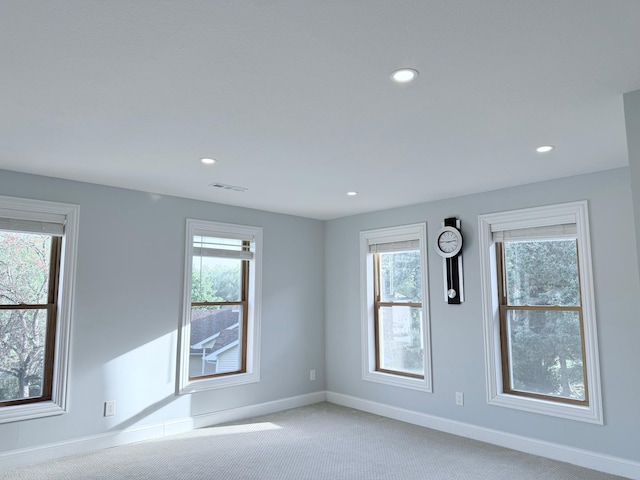 carpeted empty room with a healthy amount of sunlight