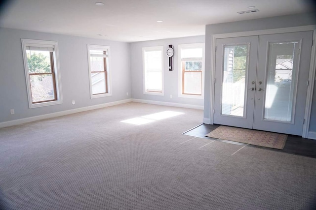 doorway featuring light carpet and french doors