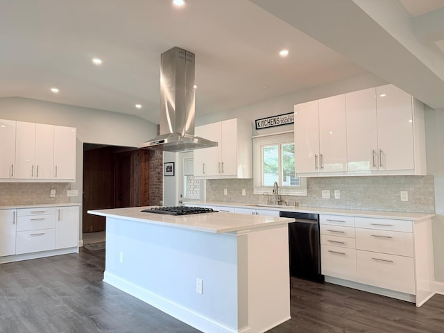 kitchen with island exhaust hood, a kitchen island, stainless steel appliances, and white cabinetry