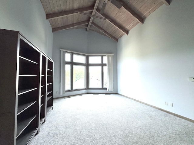 carpeted empty room with wood ceiling, beam ceiling, and high vaulted ceiling