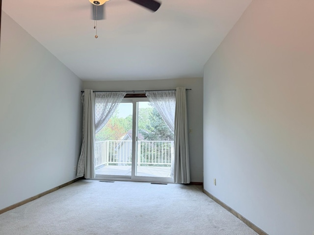 carpeted spare room with ceiling fan