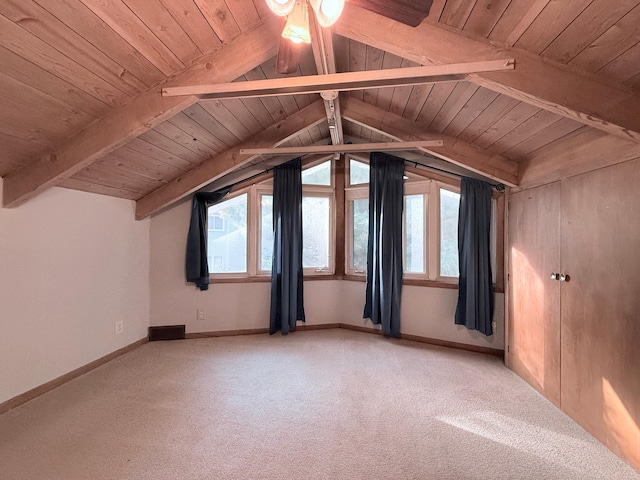 additional living space featuring carpet floors, lofted ceiling with beams, and a wealth of natural light