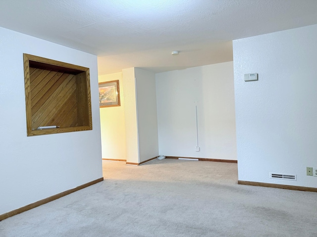 unfurnished room with light carpet