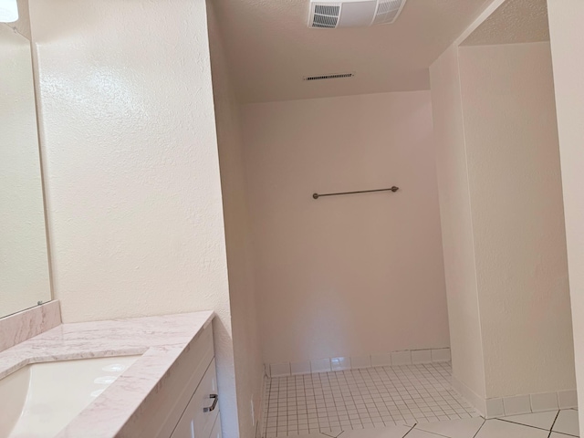 bathroom featuring vanity, a textured ceiling, and tile patterned floors