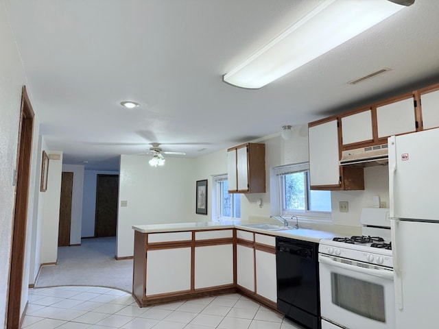 kitchen with sink, white cabinets, kitchen peninsula, white appliances, and light tile patterned floors