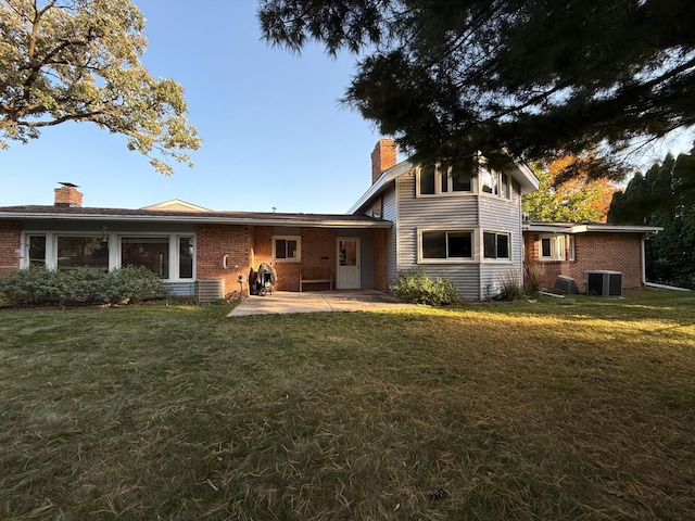 back of house with a lawn, central AC, and a patio area