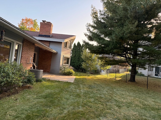 view of yard with a patio area and central air condition unit