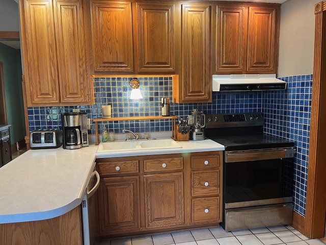 kitchen featuring sink, light tile patterned floors, decorative backsplash, and stainless steel appliances